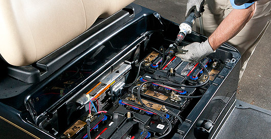 An image of someone filling their golf cart batteries using a single point watering system